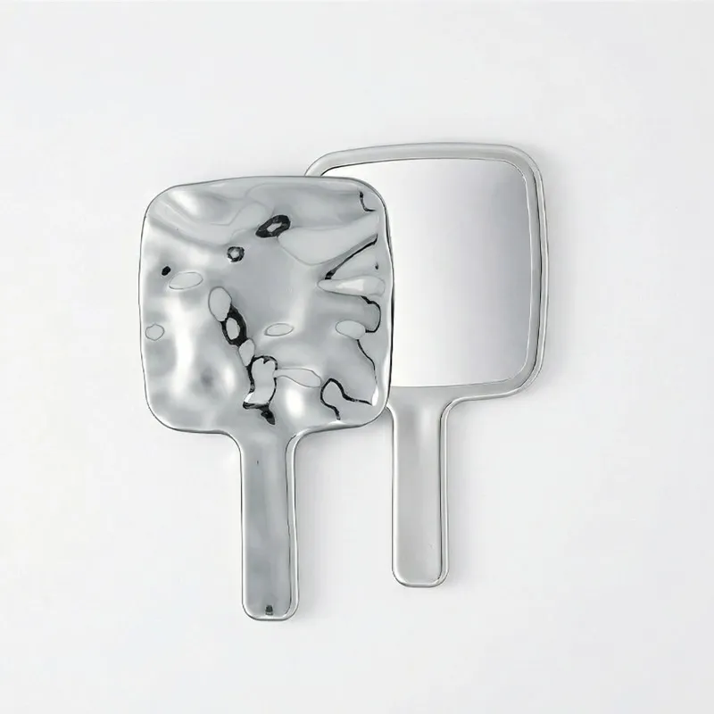 Ins-style retro handheld makeup mirror with a premium handle, portable for carrying and touch